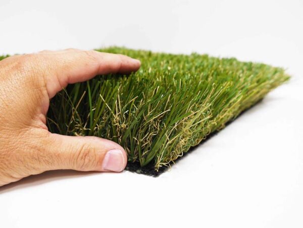 Hand touching SAGE100 artificial turf